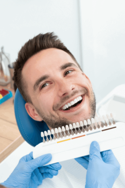 man smiling happy teeth whitening tray selection sitting dental office