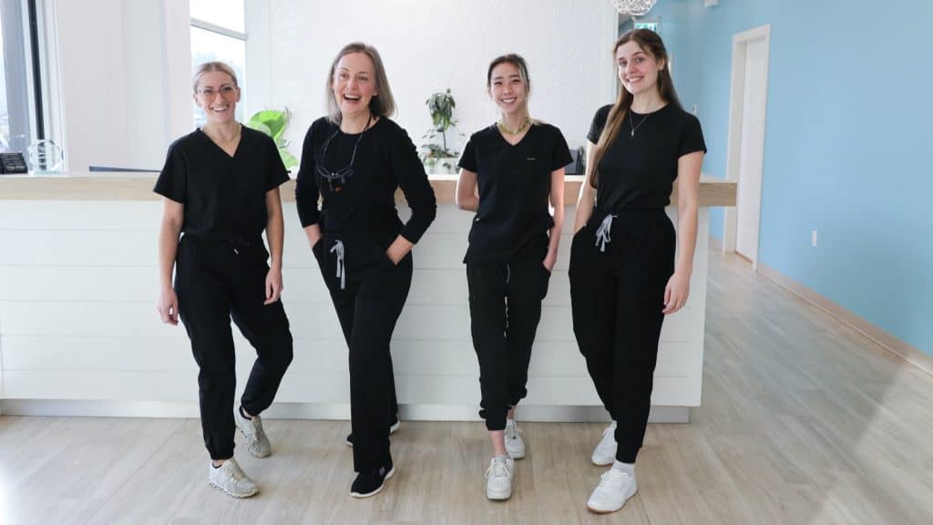 Top-rated Ladysmith dentist team smiling in modern clinic reception, friendly dental staff providing family and emergency dental care in Ladysmith, BC